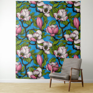 Blooming magnolia on blue tapestry