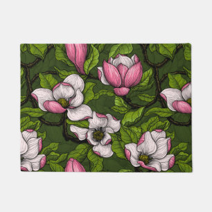 Blooming magnolia on dark green doormat