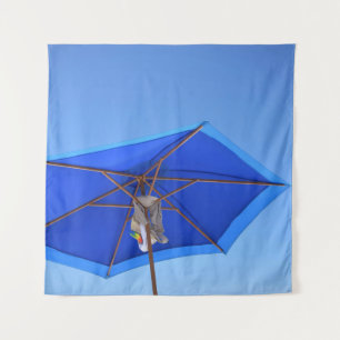 Blue and brown patio umbrella in the morning tapestry