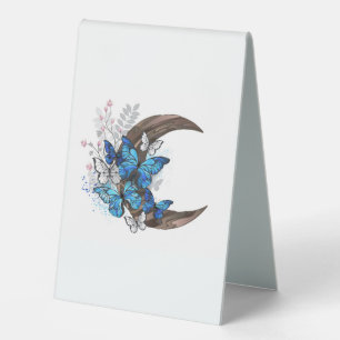 Blue butterflies on wooden crescent