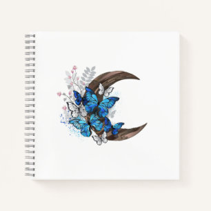 Blue butterflies on wooden crescent notebook