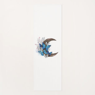 Blue butterflies on wooden crescent yoga mat