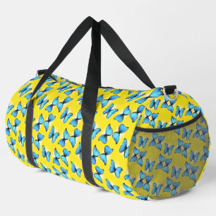Blue butterflies on yellow duffle bag