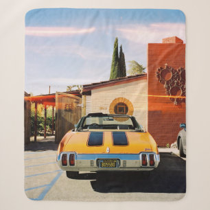 Blue car parked beside brown concrete building in  sherpa blanket