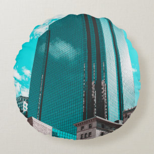 BLUE CURTAIN WALL BUILDING UNDER TEAL SKIES ROUND CUSHION