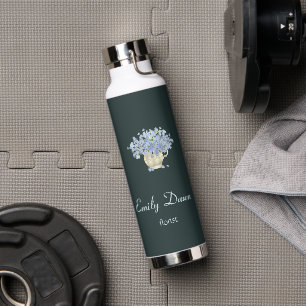 Blue flowers in vase grey water bottle