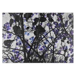 Blue flowers on winter tree concept digital art cutting board