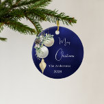 Blue gold white baubles Christmas Ceramic Ornament<br><div class="desc">A blue uneven coloured background. Decorated with white and gold baubles and some greenery and a pine cone.  Personalise and add your name,  year.  Text: Merry Christmas</div>