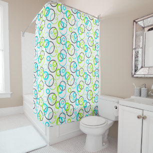 blue green and black rings and circles on white shower curtain