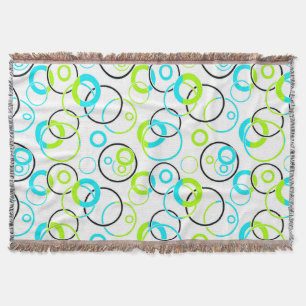 blue green and black rings and circles on white throw blanket