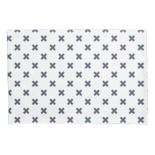 Blue-grey cross stitches on white pillowcase