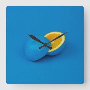 blue lemon sliced into two halves square wall clock