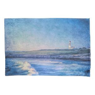 Blue lighthouse in evening and ocean waves pillowcase