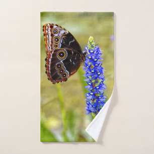Blue morpho butterfly on a marsh orchid hand towel