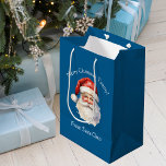 Blue Santa Claus Personalised Kids Christmas Medium Gift Bag<br><div class="desc">Customise this nostalgic from Santa Claus blue gift bag with your own personalised text with your kids name in white script. This beautiful old fashioned drawing of Santa's red hat and white beard are the perfect holiday present bags for your children's presents under the tree on Christmas day.</div>