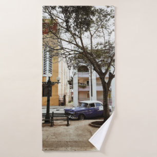BLUE SEDAN PARKED NEAR WHITE BUILDING BATH TOWEL