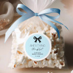Blue She's Tying The Knot Bow Classic Round Sticker<br><div class="desc">Add a touch of elegance to your bridal shower favours with these blue and black round stickers featuring a classic bow design. Perfect for sealing invitations,  decorating party favours,  or personalising gifts,  these chic stickers are easy to edit. Matching items in our store Cava Party Design.</div>