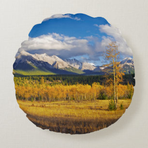 Blue skies and clouds above a meadow round cushion