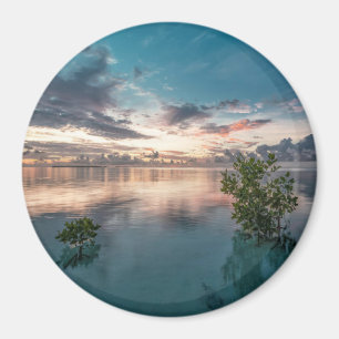 blue sky with red and dark clouds reflected on sea magnet