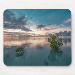 blue sky with red and dark clouds reflected on sea mouse pad