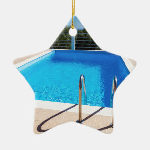 Blue swimming pool with steps at sea ceramic tree decoration