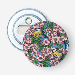 Blue tit birds in the blooming cherry tree on blue bottle opener