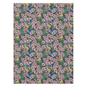 Blue tit birds in the blooming cherry tree on blue tablecloth
