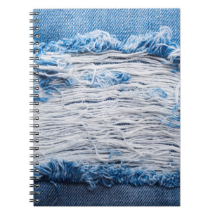 Blue torn denim jeans texture with space for text notebook