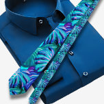 Blue Tropical Hawaiian pattern Tie<br><div class="desc">The Hawaiian print men's tie showcases a stunning illustration of tropical leaves in a captivating peacock shade. This unique colour combination adds a touch of intrigue and sophistication to the tie, making it a standout accessory for any occasion. The peacock shade, with its deep and rich hues of blue, green,...</div>