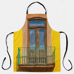 Blue wooden door on yellow concrete building apron