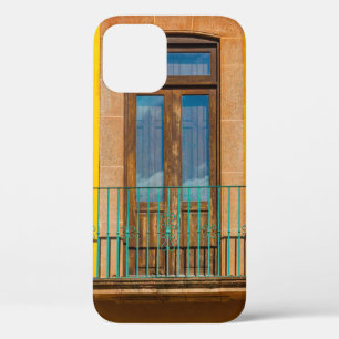 Blue wooden door on yellow concrete building iPhone 12 case