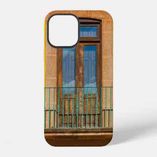 Blue wooden door on yellow concrete building iPhone 12 case
