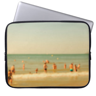 Blurred beach photo with bokeh. People relaxing on Laptop Sleeve