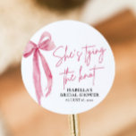 Blush Pink Bow She's Tying the Knot Bridal Shower Classic Round Sticker<br><div class="desc">The Blush Pink Bow: She's Tying the Knot Bridal Shower Classic Round Sticker is a delightful addition to any bridal shower celebration. With its elegant blush pink bow design, this sticker adds a touch of sophistication and charm to favours, envelopes, or decor. Whether used to seal envelopes, adorn gift bags,...</div>