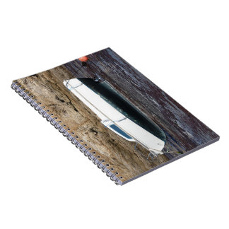 Boat grounded at mooring in an harbor notebook