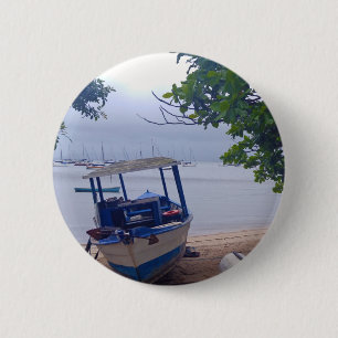 Boats stopped at the beach on a rainy day 6 cm round badge