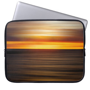 Body of water during sunset laptop sleeve