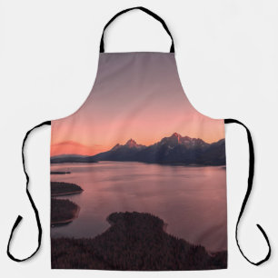 BODY OF WATER NEAR MOUNTAIN DURING SUNSET APRON