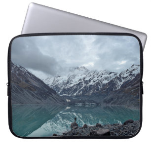 BODY OF WATER OVERLOOKING MOUNTAINS DURING DAYTIME LAPTOP SLEEVE