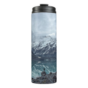 BODY OF WATER OVERLOOKING MOUNTAINS DURING DAYTIME THERMAL TUMBLER