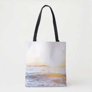 Body of water under sunset tote bag