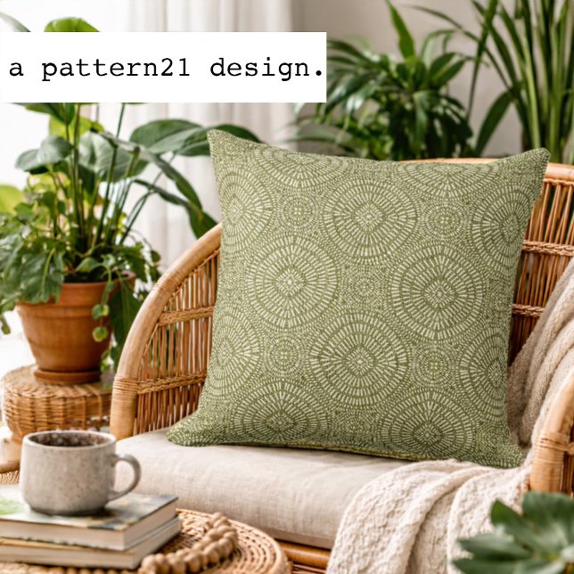 Bohemian green pattern cushion (Olive geometric accent pillow styled in a bright plant-filled living space.)