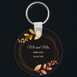 Boho autumn botanical gold frame wedding key ring<br><div class="desc">Set against a striking black background, this keychain features apricot-coloured text that provides a warm and inviting touch. Delicate leaves in soft muted earth tones and earthy autumnal copper shades evoke the cosy charm of autumn, while the geometric frame in burnt orange and terracotta adds a rustic yet sophisticated flair....</div>