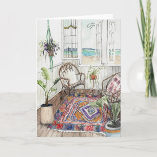 Boho beach house with the ocean seen from a window card