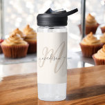 Boho Stylish Script Monogram and Name in Beige Water Bottle<br><div class="desc">A cute feminine water bottle with boho stylish lettering featuring your monogram initial in large modern font in neutral tan with your name in a charcoal grey handwritten font over a beige background. The look is modern and attractive and all about you! IPersonalize with your name and initial. When personalising...</div>