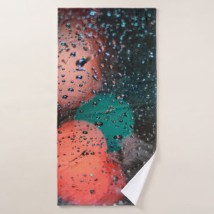 Bokeh photography of water droplets on clear glass bath towel