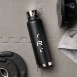 Bold Monogram on Black Water Bottle<br><div class="desc">Bold white vertical monogram on black features a larger initial in the centre. Replace the 3 initials with your own in the sidebar.

Other water bottle colours and styles available in the sidebar.

Copyright © Claire E. Skinner. All rights reserved.</div>