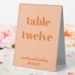 Bold Peach Orange Retro Custom Wedding Number<br><div class="desc">Guide your guests effortlessly with this stylish wedding table number sign. Featuring a modern,  minimalist design in soft Peach Orange,  this double-sided tented card is perfect for receptions,  ensuring each table is easy to find. Personalise with names and wedding date for a seamless and coordinated décor element.</div>