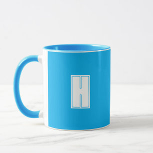Bold white initial bright blue mug