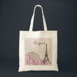 Bonjour Vintage Eiffel Tower Collage with Flowers Tote Bag<br><div class="desc">A whimsical vintage collage which has an old french postcard background with an eiffel tower sketch and some pink and white wildflowers bordering the bottom. Fancy swirly embellishments decorate the sides.
Bonjour written in a black handwritten font.</div>
